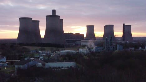 Fiddlers-Ferry-disused-coal-fired-power-station-at-sunrise,-Aerial-view-rising-towards-industrial-landmark