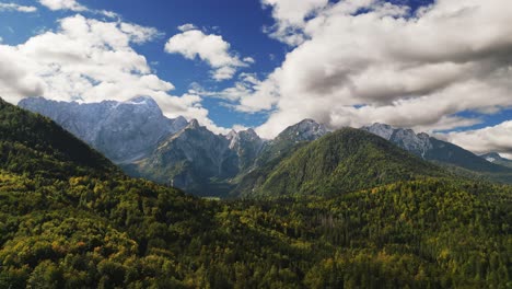 Beautiful-Grand-Mountains-Valley-Italy,-Julian-Alps,-Aerial-Drone-Dolly,-Sunny-Green-Trees,-Blue-Sky-With-Clouds,-Idyllic-Travel-Destination-Tourism,-Vacation-Location