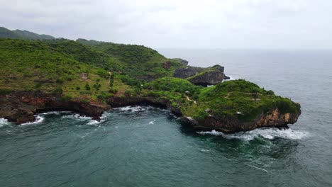 Aerial-view-of-coral-reef-with-green-plants-on-hill-during-cloudy-day---KESIRAT-CLIFF,-YOGYAKARTA,-INDONESIA