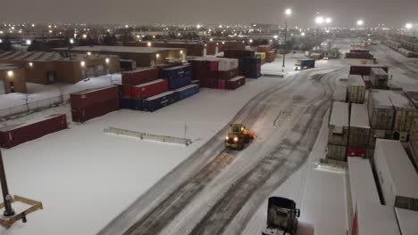 Warehouse-Snow-Removal:-Snow-Plow-Clears-the-Road-for-Shipping-Operations-at-Commercial-Warehouse
