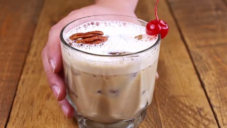 closeup-of-kahlua-drink-with-coffee,-alcohol-and-milk-on-a-wooden-table