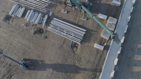 High-above-drone-shot-of-crane-plus-material-on-construction-site