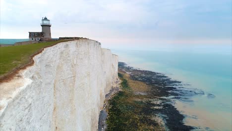 aerial-lighthouse-white-cliffs-of-dover-ocean-england-travel-cinematic-drone