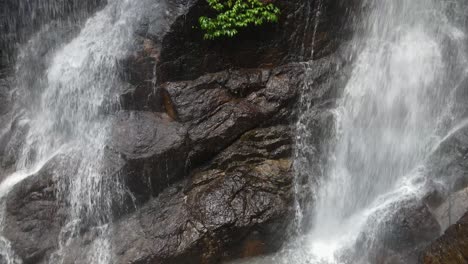 Slow-climbing-view-following-a-twin-cascading-waterfalls-and-secluded-natural-rock-pool