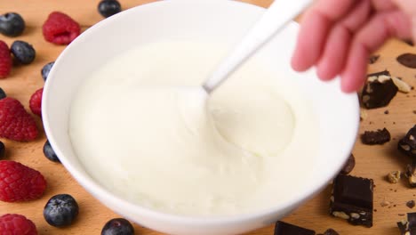 Stirring-a-bowl-of-plain-yogurt