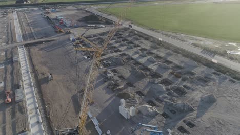 Drone-shot-of-very-big-construction-site-with-big-crane