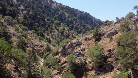 Scenic-drone-flight-up-Imbros-Gorge-with-sparse-vegetation-in-Crete,-Greece