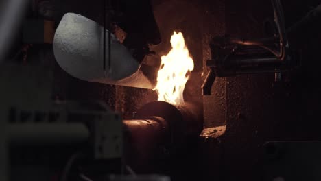 Metal-foundry-pours-molten-metal-with-flames