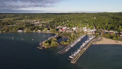 Suttons-Bay-town-with-pier-and-boats,-aerial-drone-view