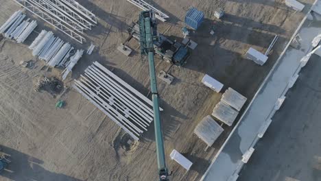 Drone-shot-above-a-construction-site-with-machine-and-material