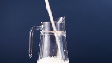 Milk-being-poured-into-a-big-pitcher-from-above