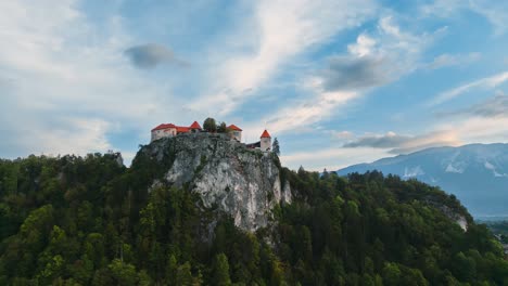 Castle-Fortress-On-Steep-Rocky-Cliff,-Bled-Slovenia,-Interesting-Historical-Travel-Location,-Aerial-Low-Angle-Drone-Shot,-Epic-Cinematic-4K