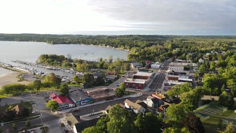 Cozy-town-of-Suttons-Bay-with-boats-moored-in-pier,-aerial-drone-view