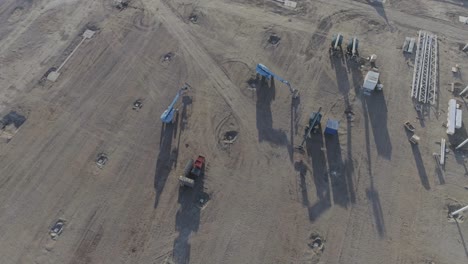 Drone-shot-of-construction-site-with-machines-and-material