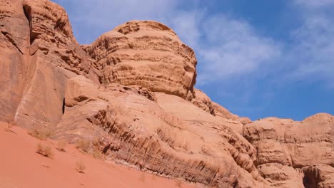 Wild-and-rugged-red-sandstone-mountain-landscape-against-blue-sky-in-the-desert-of-Wadi-Rum,-Jordan,-Middle-East