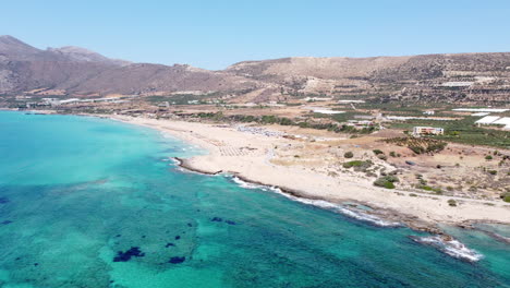 Panoramic-aerial-view-over-clear-blue-ocean-and-famous-Falassarna-Beach,-Crete