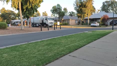 Yarrawonga,-Victoria,-Australia---24-February-2023:-Rubbish-truck-turning-around-a-tight-corner-in-a-quiet-suburban-street-in-Australia
