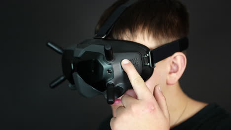 Close-Up-of-Young-Man-Touching-Buttons-on-VR-Headset,-Virtual-Reality-and-Gaming-Concept