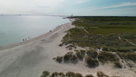 Aerial-Pan-of-Skagen-Grenen-Beachside-with-Sand-Dunes-and-Lighthouse,-Denmark