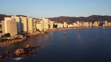 Aerial-drone-shot-of-the-bay-of-Acapulco-at-sunset