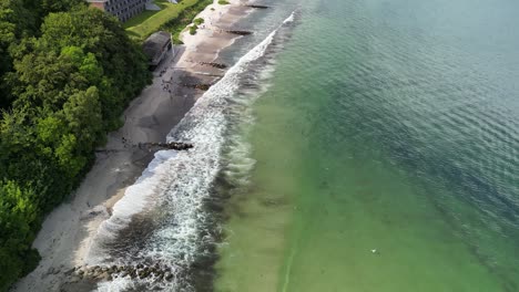 Aerial-Descent-of-Beach-with-Waves-Breaking,-Aarhus,-Denmark