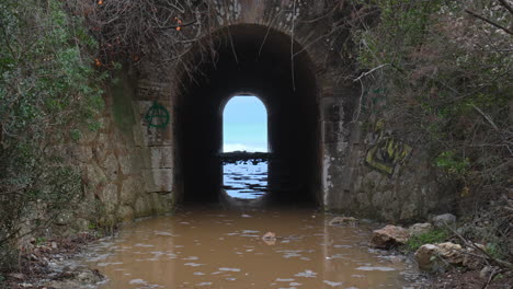Un-Túnel-Conduce-Hacia-Un-Mar-Salvaje,-Donde-Las-Olas-Crean-Un-Efecto-Ondulante