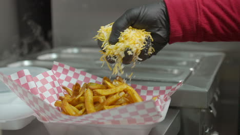 Adding-cheese-and-marinated-meat-while-making-carne-asada-smothered-fries---food-truck-series