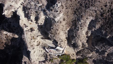 Aerial-view-flying-over-white-church-on-Santorini-caldera-Greece