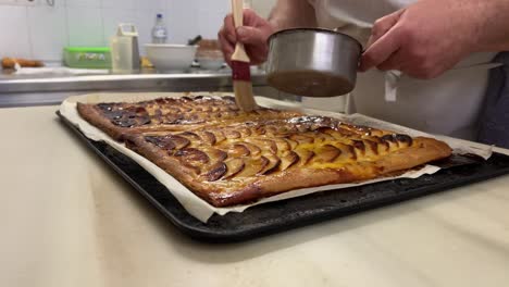 Traditional-baker-prepares-bio-homemade-apple-cake-in-his-bakery