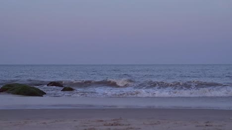 Waves-crashing-on-beach-during-sunset