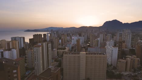 Aerial-wide-panorama-of-Benidorm-cityscape-with-skyscraper-building-at-sunset