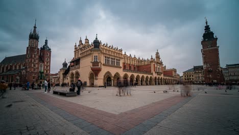Infinite-loop-time-lapse-of-Stare-Miasto,-Rynek-Główny-Krakow-Old-Town-in-a-cloudy-day-of-winter-with-the-Basilica-of-Saint-Mary-and-Town-Hall-Tower-in-the-background