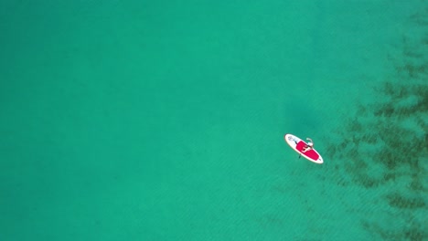 drone-view-of-Women-paddleboarding-on-the-clear-emerald-gulf-of-Mexico-on-a-bright-sunny-day