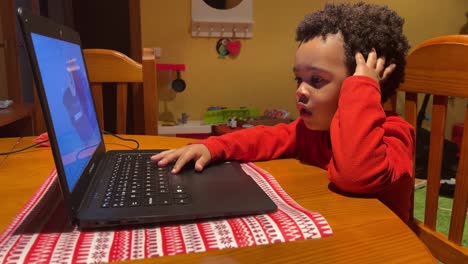 Two-year-old-black-baby,-mix-raced,-playing-with-a-laptop-at-home