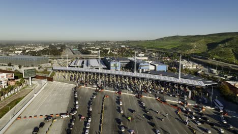 Cars-queuing-at-the-San-Ysidro-Port-of-Entry,-in-Tijuana,-Mexico---Ascending,-aerial-view