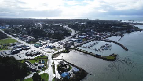 Beautiful-4K-aerial-drone-shot-peaking-over-Old-Town-Bandon-in-Southern-Oregon