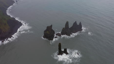 Aerial:-Reynisdrangar-sea-stacks-in-Reynishjara-black-sand-beach-in-Iceland