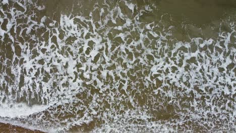 Sideways-Aerial-Drone-Shot-of-Sea-Waves-Rolling-into-Mewslade-Bay-in-Gower-Wales-UK-4K