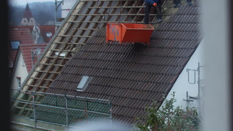 Slow-motion-shot-of-a-roof-getting-removed-tile-by-tile