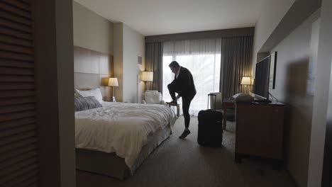 Business-Man-in-Suit-Entering-Hotel-Room---Jumping-on-Bed