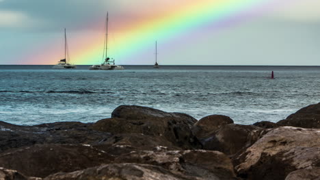 Timelapse-of-colorful-rainbow-disappearing-while-rain-shower-moves-over-horizon