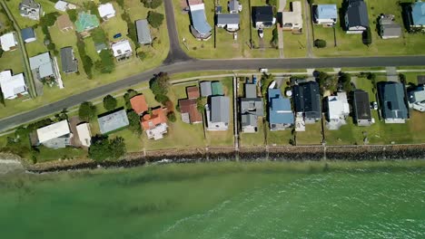 Top-down-aerial-view-of-beach-front-luxury-homes-along-the-coast