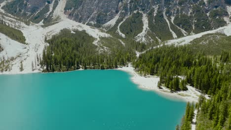 Aerial-Drone-shot-of-the-Dolomites-Alps,-the-river-and-the-mountains,-Lago-di-Braies,-Italy,-Dolomites