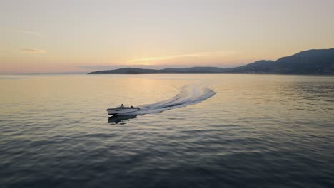 Droneshot-of-speedboat-riding-in-the-sunset