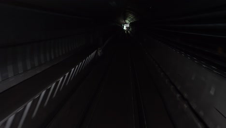 Dark-tunnel-view-of-the-metro-line-number-4-arriving-to-Bikas-Park-Metro-stop,-Kelety-Kelenfold
