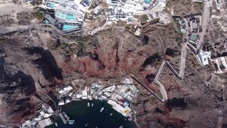 Aerial-Drone-Video-Of-Beautiful-Bay-Of-Ammoudi-Below-Oia,-Picturesque-Village-of-Santorini,-Greece