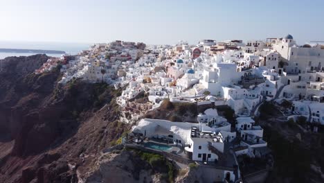 Aerial-View-Flying-Over-City-Of-Oia-On-Santorini-Greece