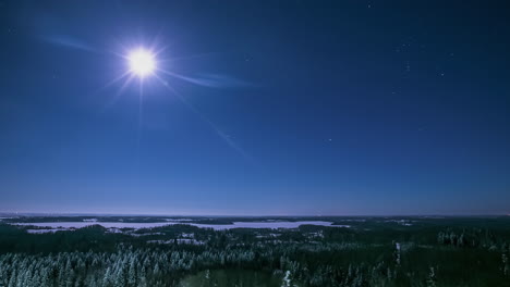 Moon-and-stars-over-a-winter-landscape-wilderness---nighttime-time-lapse
