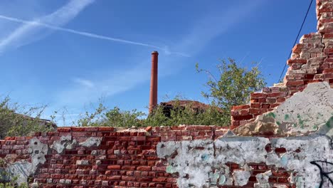 Abandoned-factory-Algarve-Portugal,-chimney-and-brickwork-form-interesting-artwork