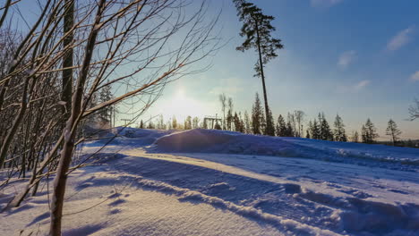 Timelapse-of-snow-shovels-moving-over-a-ski-slope-during-sunset